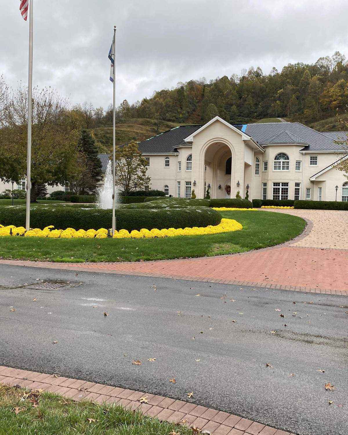 The entrance drive, fountain island and seasonal color at a commercial property under a Valley Gardens grounds contract