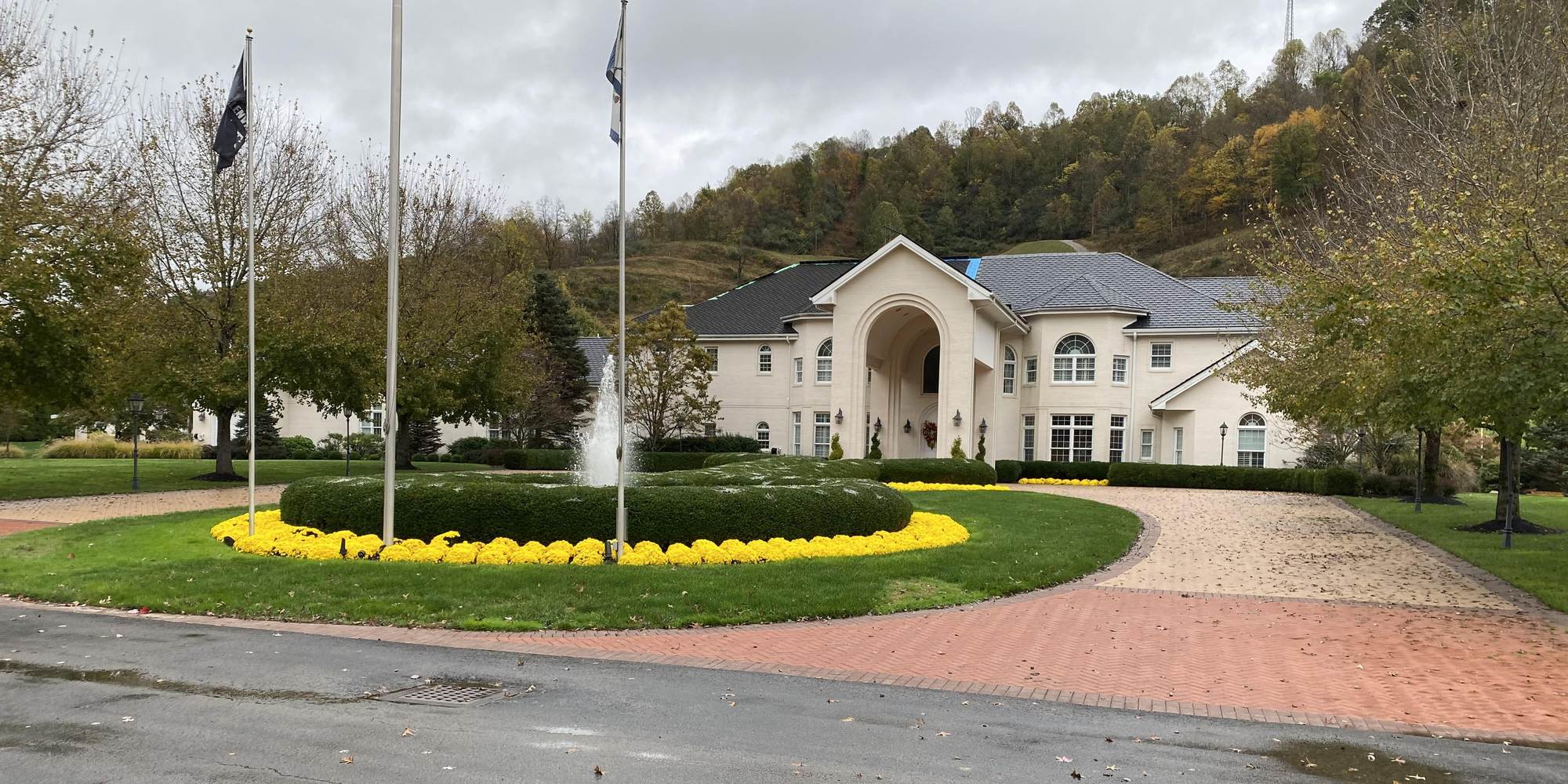 Circular entrance drive, fountain and seasonal plantings at a commercial property maintained by Valley Gardens