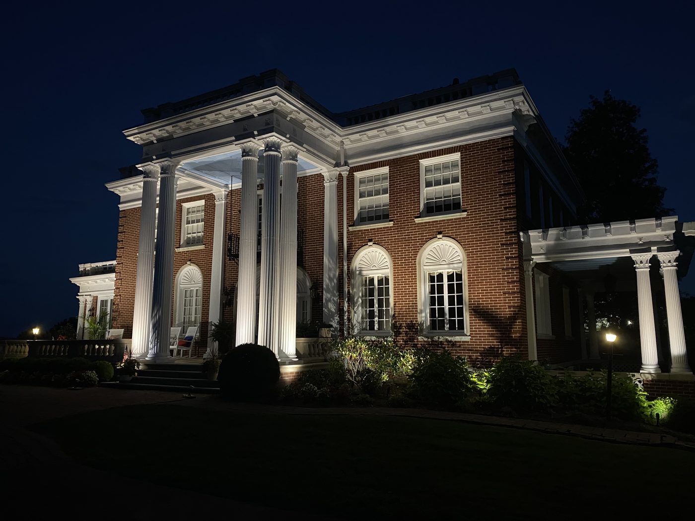 Landscape and architectural lighting on a brick residence at night